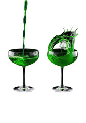 two pristine vintage coupe glasses on reflective black, vibrant emerald green cocktail pouring and splashing in frozen motion, high-contrast studio setup, volumetric light. concept for dynamic