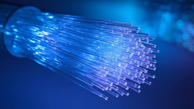 Close-up of illuminated fiber optics bundle against a blue background, technology concept with data transmission.