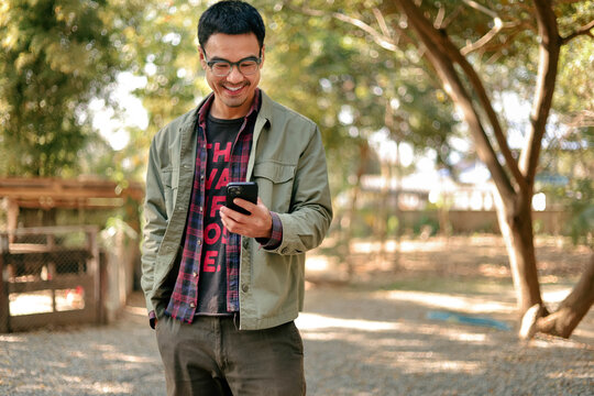 man using mobile phone holding cell phone texting message contact us.chatting,search internet shopping online.device communication connecting