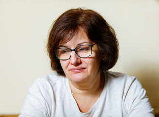 Fototapeta premium Caucasian mature female with glasses in thoughtful pose