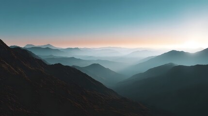 Majestic misty mountain layers recede into the distance at sunrise showcasing a serene natural landscape with soft atmospheric hues
