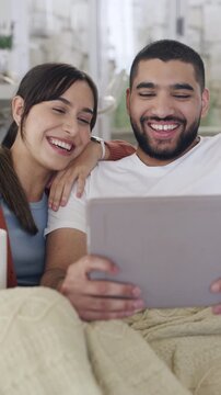 Smile, couple and relax with tablet in home on social media, browsing website and watching movies. Happy, people and digital for streaming, funny film and bonding together for weekend break in lounge