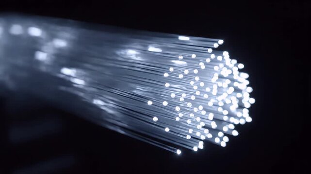 Fiber Optic Cables Transmitting Digital Data with Bright Light Pulses Illuminating Tips on Black