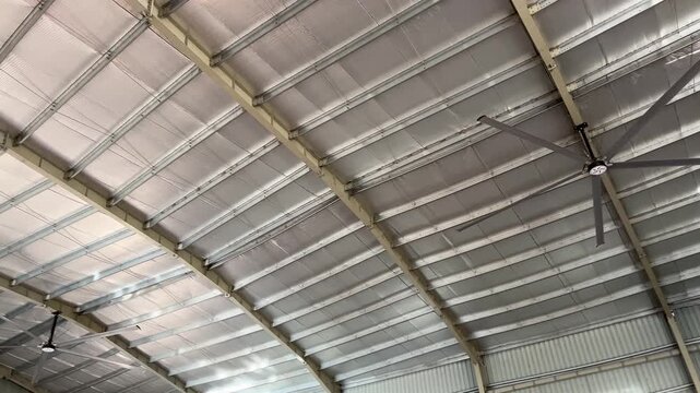 Industrial warehouse ceiling with thermal insulation and large circulation fans