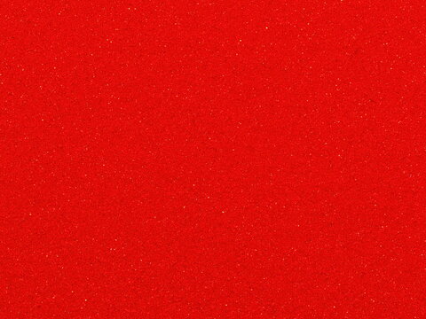 Macro photography of smooth bright red car paint texture with subtle sparkle