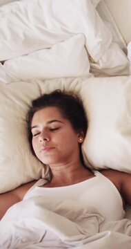 Frustrated, woman and annoyed with snoring in bed for noise, sleep deprivation or insomnia above. Top view, tired or female person covering ears with pillow for noisy man, irritation or loud sound