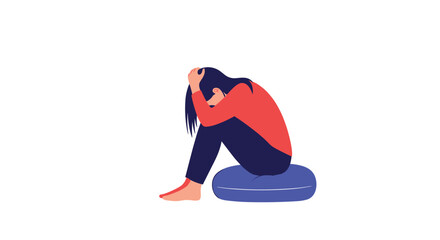 A woman sits curled up on a blue cushion with her head in her hands, depicting feelings of sadness, depression, anxiety, or grief.
