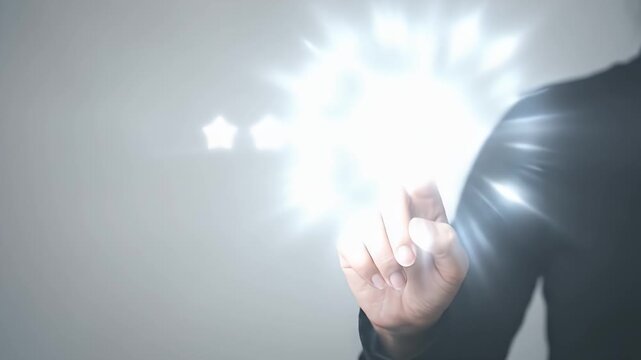 Close-up of a persons finger touching the fifth glowing white star in a row, the star pulses with bright light upon contact against a neutral grey background, static framing with soft studio lighting,
