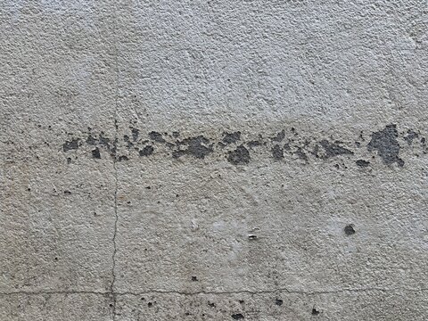 Weathered concrete wall texture with peeling paint and cracks