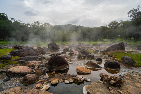 Jae son Hot Spring: Steam from geothermal heat rises from the spring. Located in Jae son National Park, Lampang Province, Thailand.