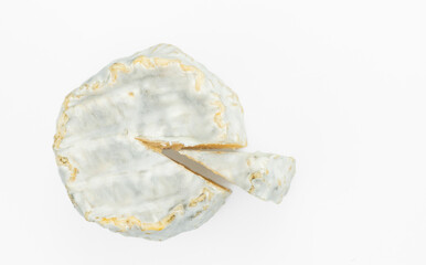 Traditional French goat cheese Crottin de Chavignol isolated on a white background.