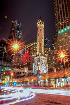 Chicago, IL&mdash;March 29, 2018; The historic Chicago Water Tower rises above Michigan Avenue at night with city lights and long-exposure traffic trails creating a vibrant downtown scene