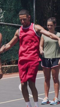 Active, fitness and skipping with people on basketball court together for bonding, health or wellness. Exercise, jump rope and challenge with group of friends outdoor for cardio, sports or training
