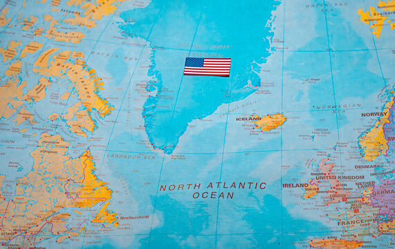 US flag on Greenland map representing territorial claim and influence.