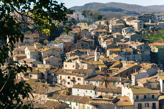 Tolfa hill town with terracotta roofs and church tower