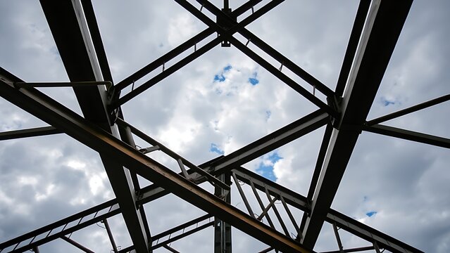 exposed. Industrial metal framework against cloudy sky, showcasing structural textures with dramatic lighting. travel magazines.
