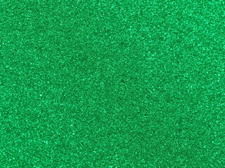 Fototapeta premium Macro photography of vibrant green metallic paint texture with fine sparkles