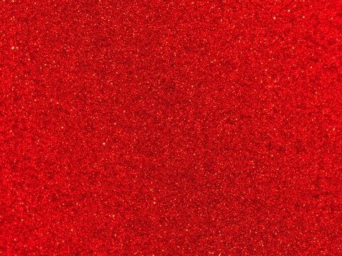 Macro photography of vibrant ruby red metallic paint texture with fine sparkles