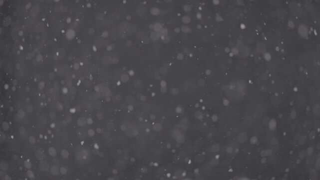 Slow motion falling snow particles on background, cinematic winter atmosphere with dense blizzard effect, swirling flakes, bokeh for overlays. ProRes 422, 10 bit ungraded C-LOG2, Slow motion video.