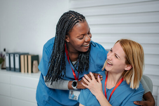Two happy nurses enjoying a friendly moment at work