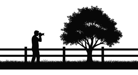 A photographer stands with camera near a tree and fence creating a striking black silhouette high quality professional detailed modern elegant © CreativeAkash099