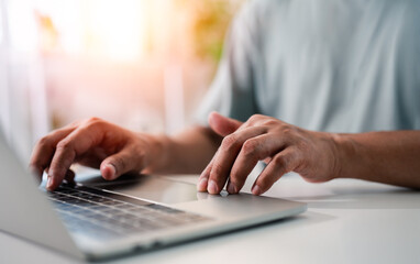 Close-up A Businessman typing laptop computer communicates on internet technology on office desk. Workplace, Businessman professional working on new job project. Business technology concept.
