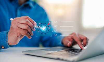 Fototapeta premium Businessman working laptop computer select target goals strategic for business purpose, goal achievement futuristic innovation for strategic planning. Strategic planning for business target concept.