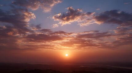Fototapeta premium A dramatic sunrise paints the sky with vibrant hues of orange pink and purple over a serene landscape