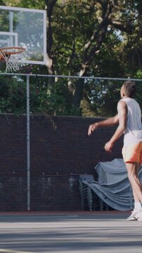 People, training and shooting basketball on court with score, target success and prepare for contest. Men, play sport and game outdoor with hoop, three pointer and practice technique for competition.