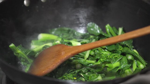 Steaming Chinese Kale Stir-Fried in Wok with Wooden Spoon, Cantonese Cuisine, Guangzhou, China