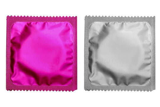 Close up of a pink condom on white background, wrappers in square and rectangle packaging on white background - Clipping Path.