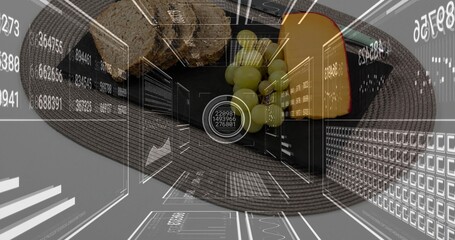 Fototapeta premium Showing black plate holding wedge cheese with red-rind, grapes and bread on placemat, HUD overlays