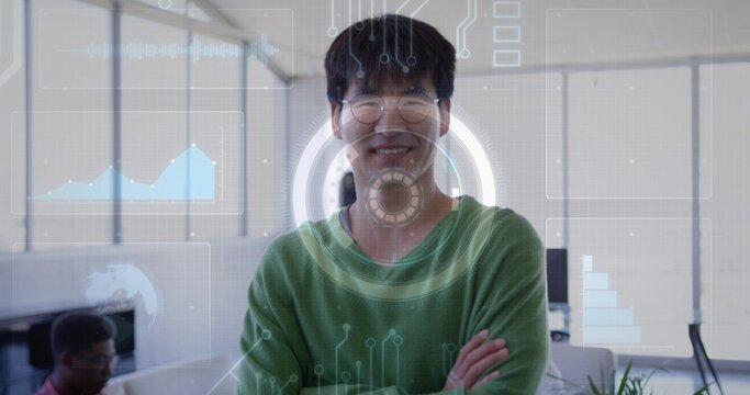 Standing 30s Korean employee crossing arms, smiling in office with round-glasses green-sweater HUD