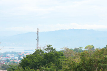 Obraz premium green forest view with hill and city background on the side