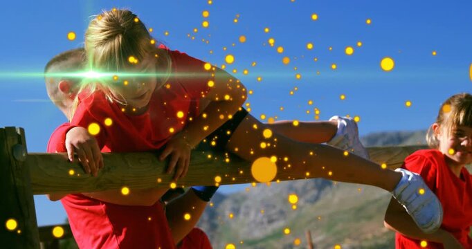Coach lifting girl onto rail steadying crossing for fitness while yellow dots and flares overlaying
