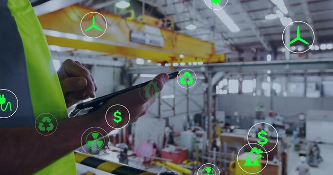 Supervisor tapping tablet with stylus, monitoring energy CO2 metrics as green icons overlay factory