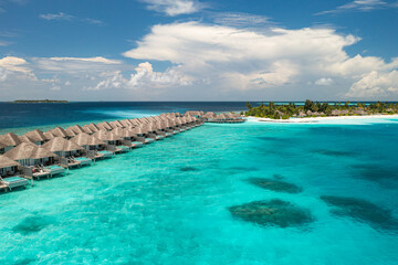 Aerial view of Maldives water villas on tropical island paradise for luxury vacation landscape...