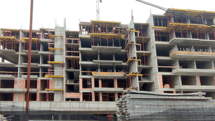 monolithic concrete residential complex under construction with multiple sections