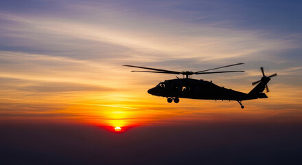 Obraz premium Helicopter Silhouette Flying During Golden Sunset