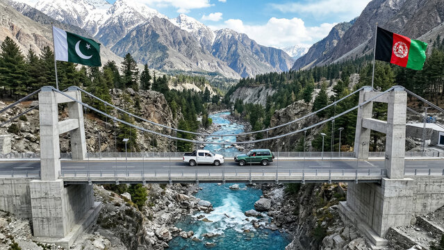 modern suspension bridge over mountain river connecting banks with flags of pakistan and afghanistan