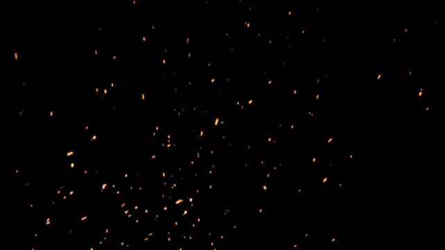 Fast flying fire embers and sparks on black background. Burning orange ash particles drifting upward. hot fire dust overlay. seamless 4K loop