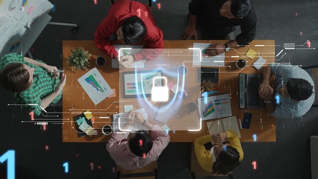 A diverse group of professionals engages in a collaborative meeting, focused on discussing data security strategies and innovative technology solutions in a modern office environment. Raster