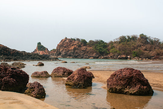 Rocky Shoreline With Gentle Sea Water At Nivati Beach in Maharashtra, India