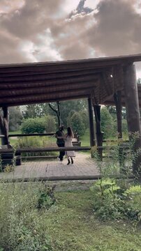 Dancing couple in park, wide angle. Outdoor lifestyle with dynamic movement, summer natural outdoors