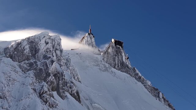 Aiguille du Midi snow capped peak Chamonix France blue sky