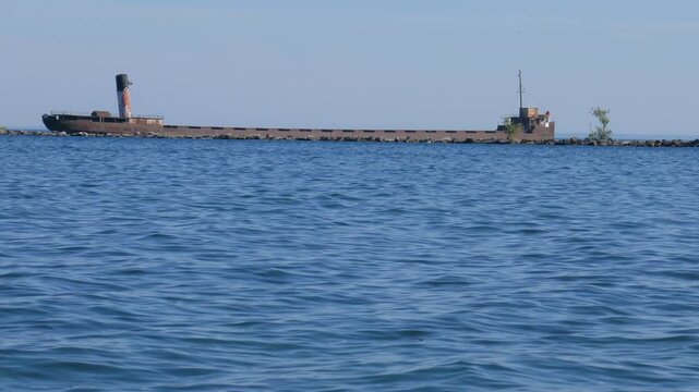 Ship at the mouth of the Credit River in Port Credit, Mississauga, Ontario, Canada on the north shore of Lake Ontario.