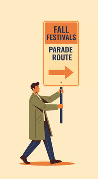 Man Holding Fall Festivals Parade Route Sign Showing Direction
