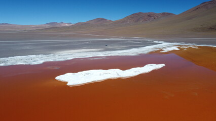 Naklejka premium Aerial Drone View of Laguna Colorada, Bolivia with Camper Van in Remote Andean Landscape