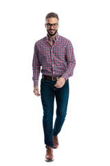 Fototapeta premium Happy casual man wearing glasses walking forward