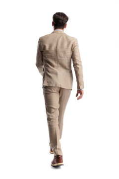 Back view of stylish man walking away